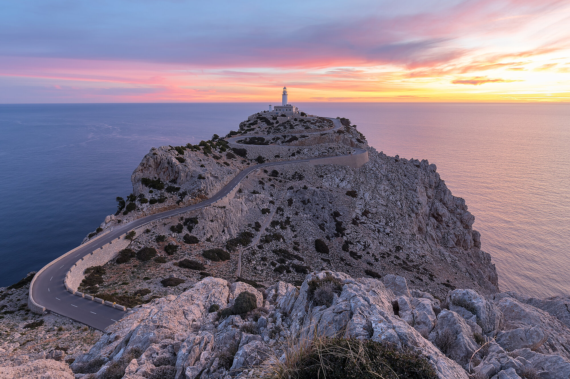 Cliff in the Balearic Islands, road in the foreground, sea in the background